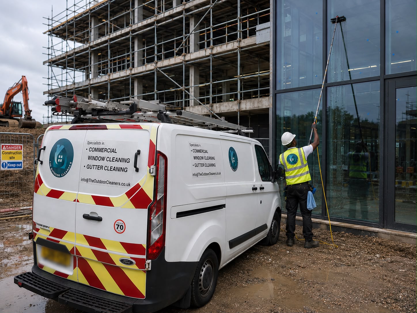 Commercial cleaner working on glazing at a construction site